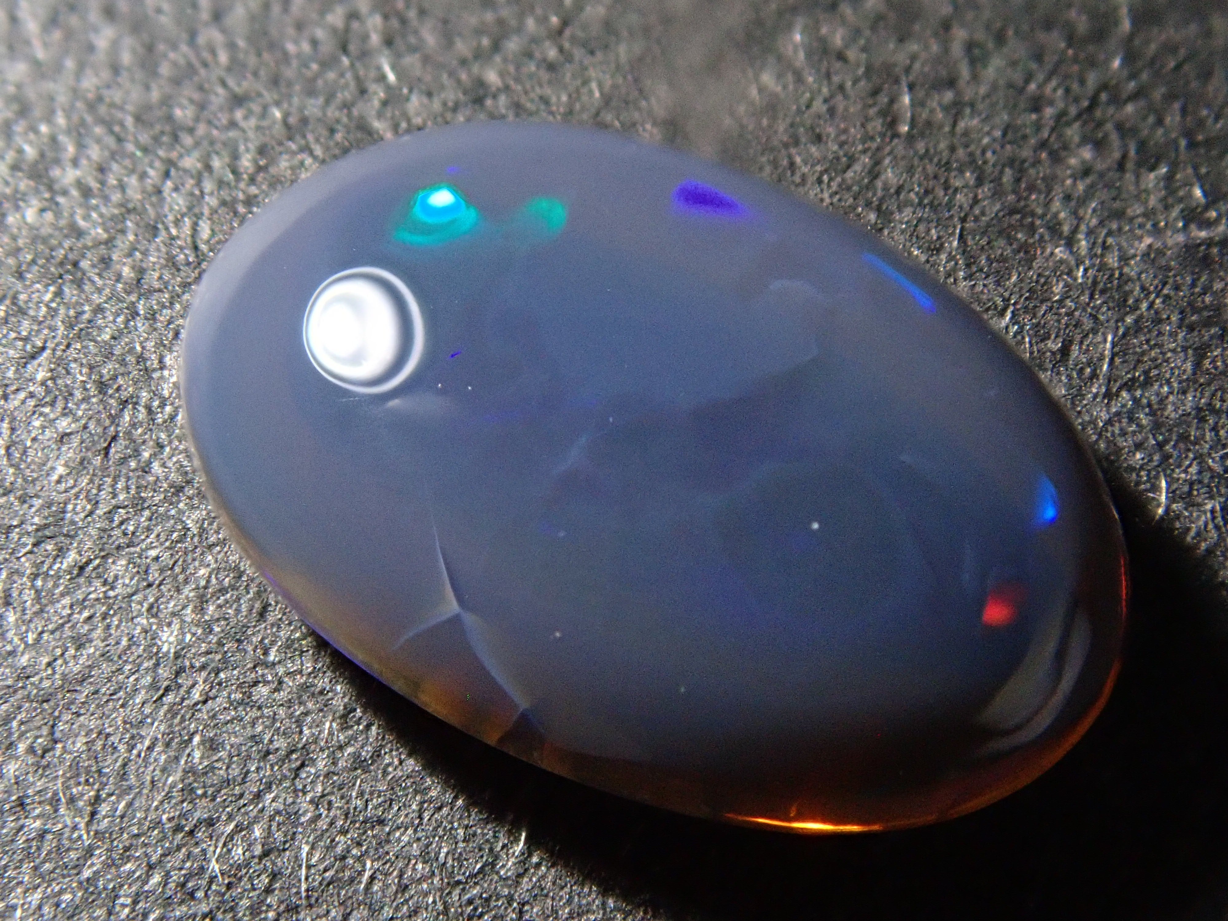 Loose Australian black opal, 0.755 ct