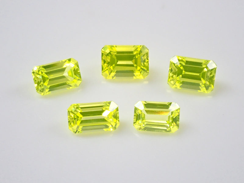 Set of 2 stones: 1 YAG (yttrium aluminum garnet) stone (canary yellow, emerald cut) + 1 yellow sapphire rough stone (discount available for multiple purchases)