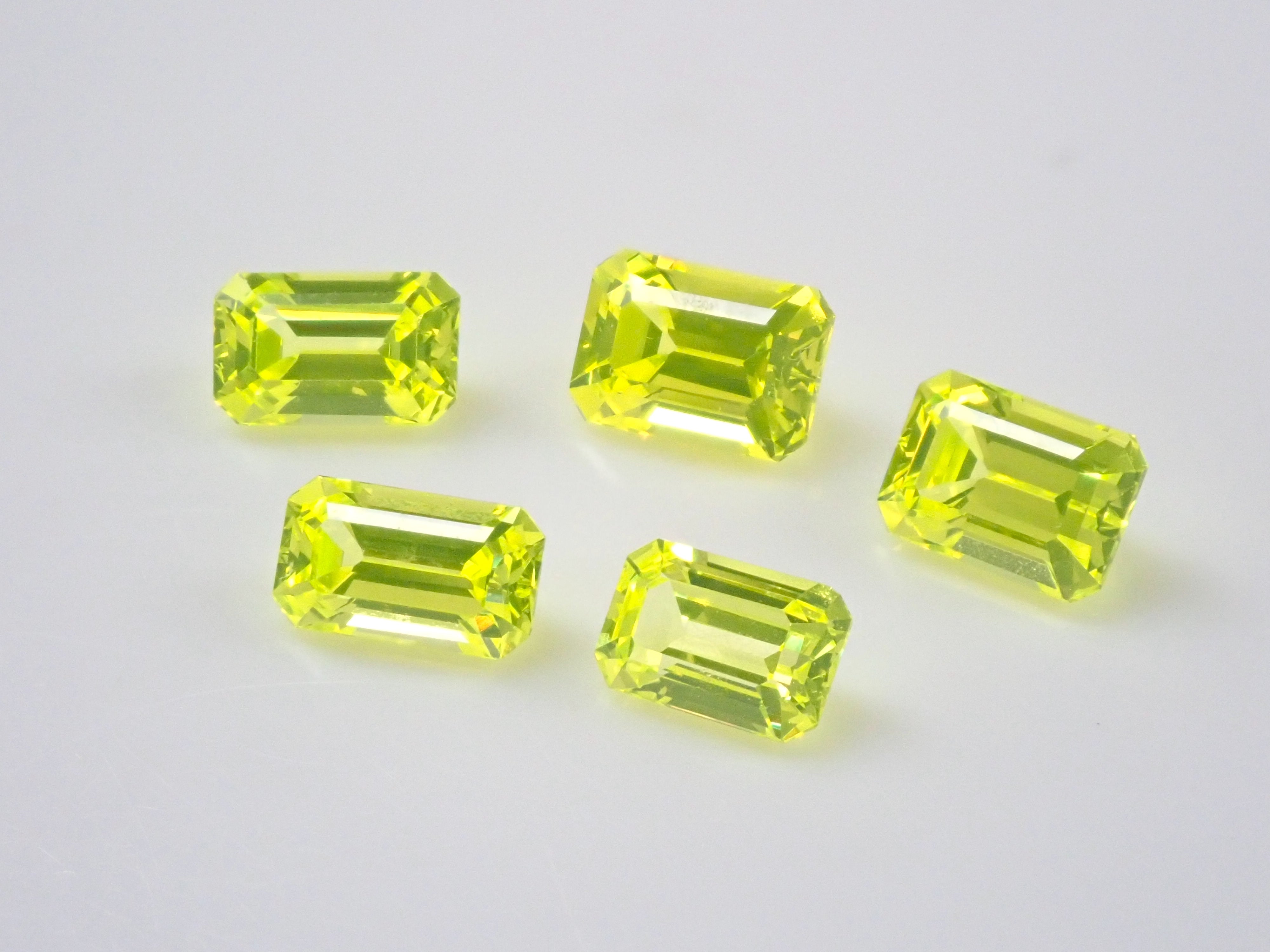 Set of 2 stones: 1 YAG (yttrium aluminum garnet) stone (canary yellow, emerald cut) + 1 yellow sapphire rough stone (discount available for multiple purchases)